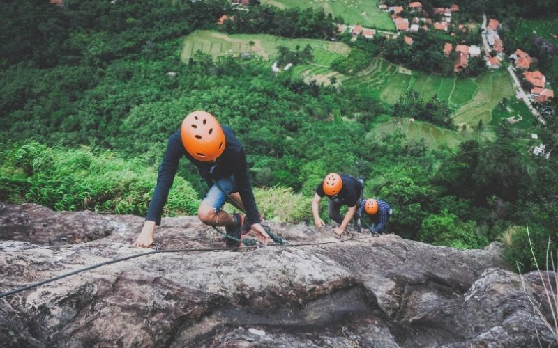 Rock climbing adventure trip with SidespinAdventures featuring guided climbs on natural rock faces.