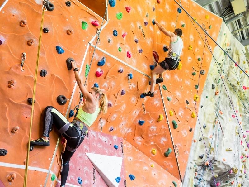 Sport climbing on natural rock faces using pre-fixed anchors with instructor supervision.